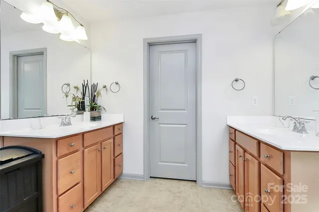 a bathroom with a sink double vanity and a mirror