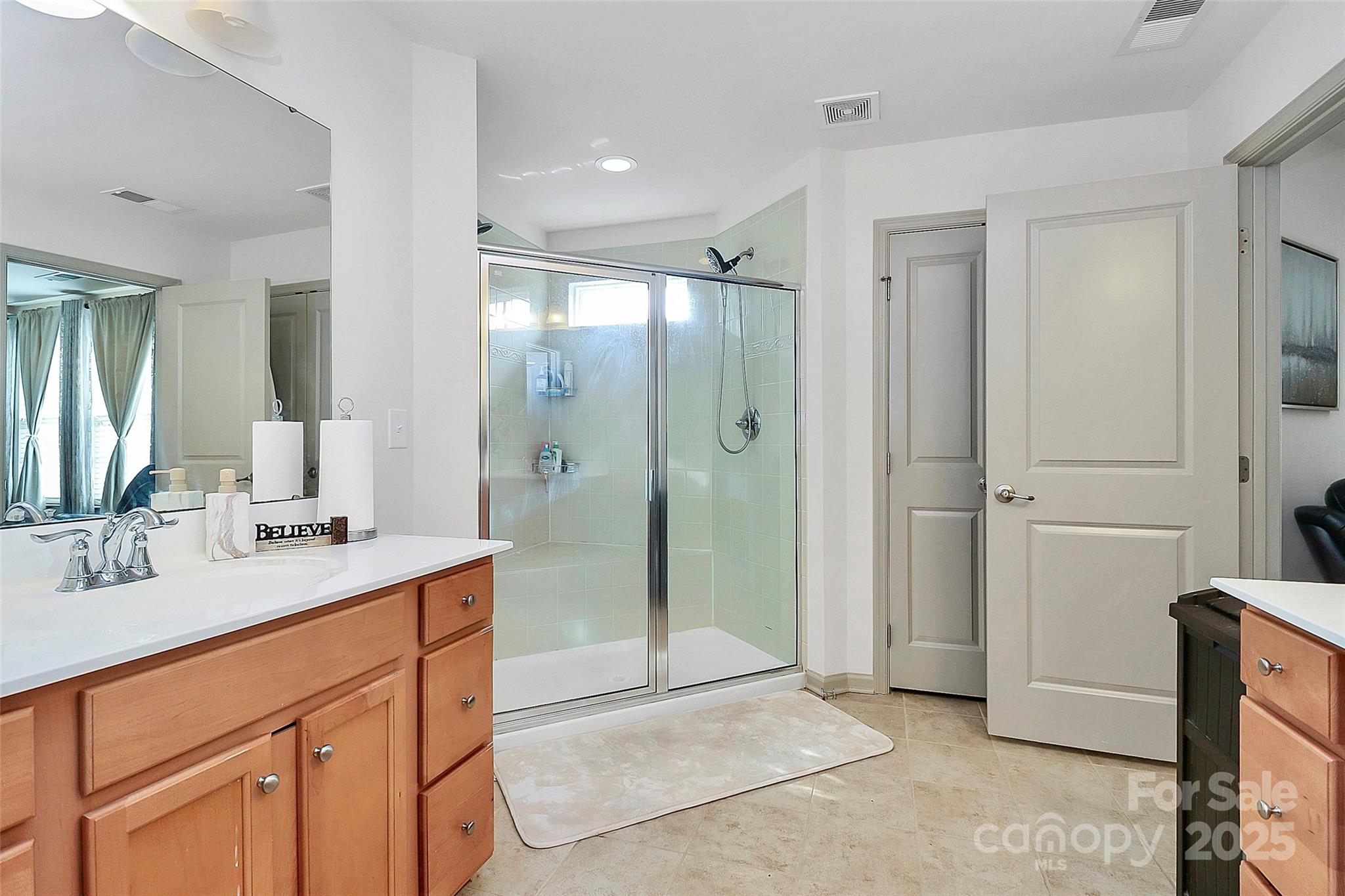 7362 Millstone Circle Southwest Concord, NC 28025 - Photo 33 of 45 a bathroom with a shower sink and mirror