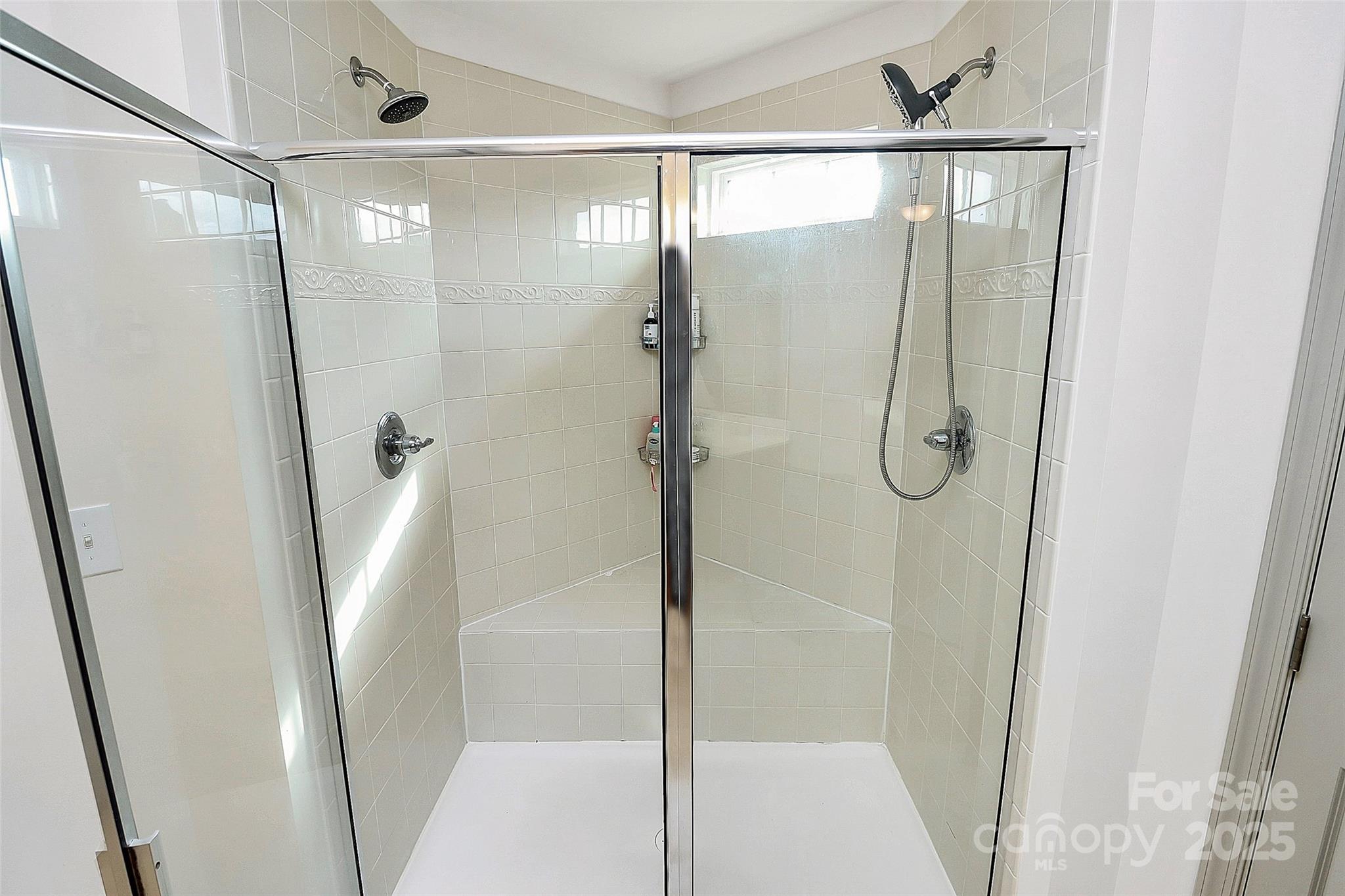 7362 Millstone Circle Southwest Concord, NC 28025 - Photo 34 of 45 a bathroom with a glass shower door
