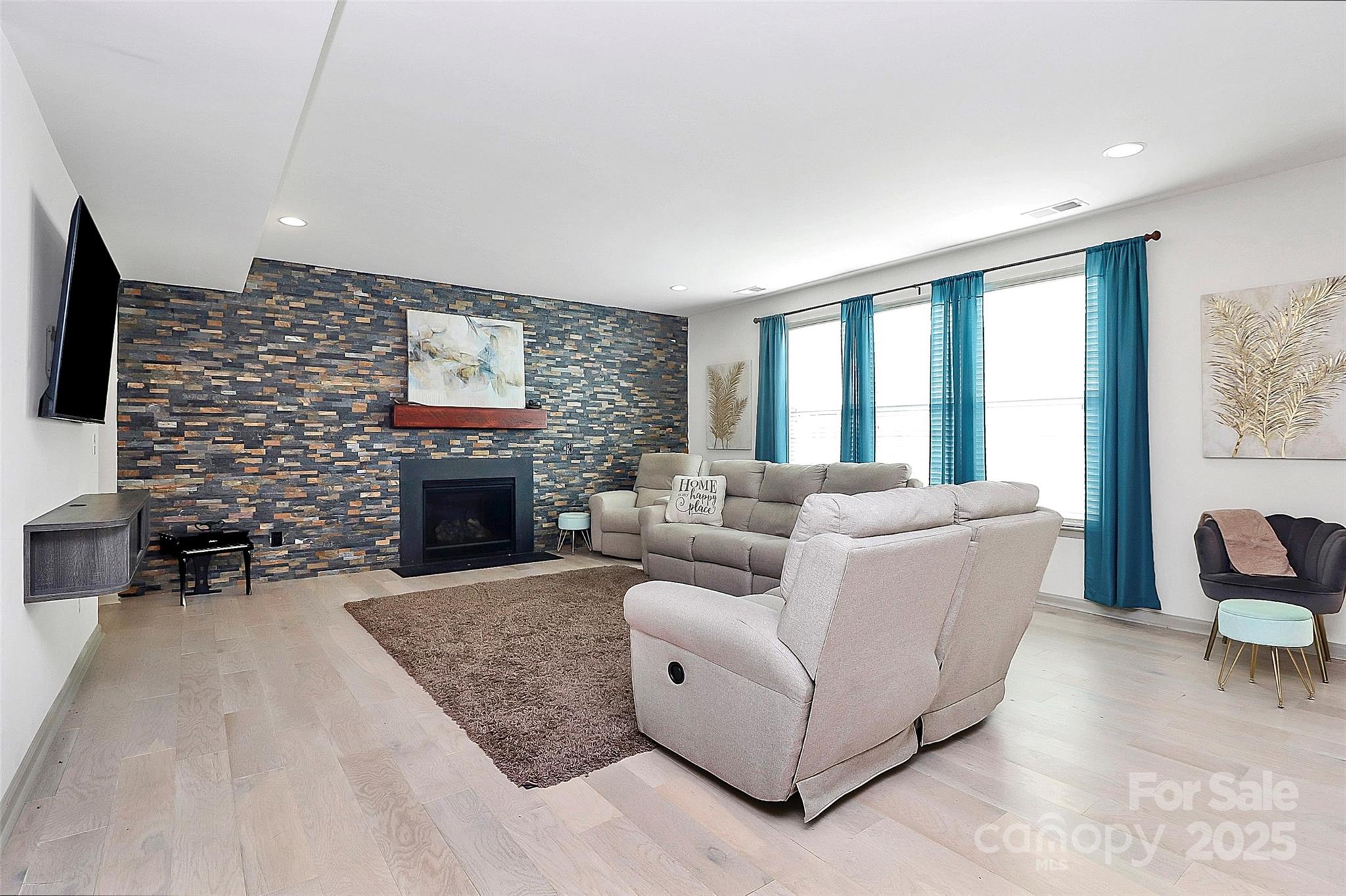 7362 Millstone Circle Southwest Concord, NC 28025 - Photo 5 of 45 a living room with furniture a large window and a fireplace