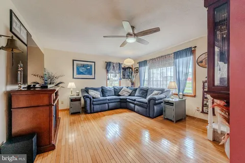 a spacious bedroom with a bed and a flat screen tv