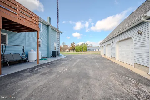 a view of living room with furniture and a book shelf