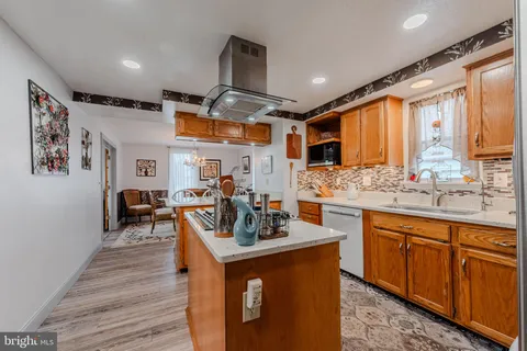 a kitchen with stainless steel appliances granite countertop a refrigerator a stove and a sink