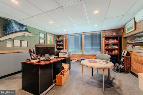 an aerial view of a house with yard swimming pool and lake view