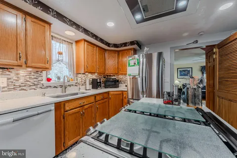 a dining room with furniture a chandelier and wooden floor