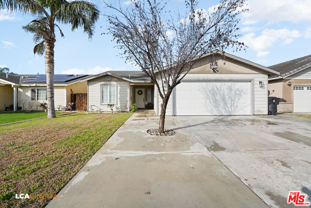 5612 McKee Road Bakersfield, CA 93313 - Photo 1 of 22 a front view of a house with a yard and garage