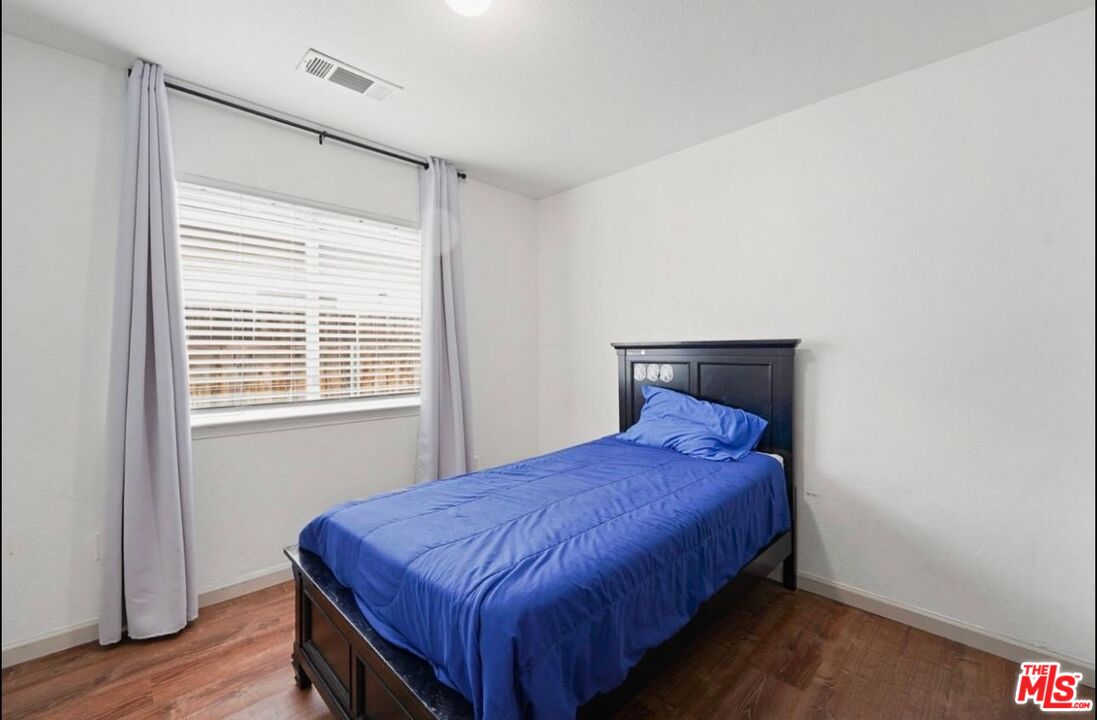 5612 McKee Road Bakersfield, CA 93313 - Photo 13 of 22 a bed sitting in a bedroom next to a window