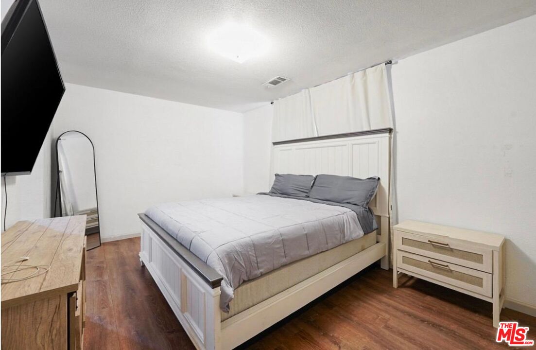 5612 McKee Road Bakersfield, CA 93313 - Photo 14 of 22 a large bed sitting in a bedroom next to a window