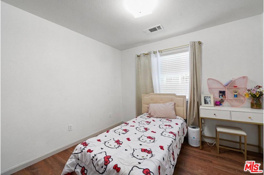 5612 McKee Road Bakersfield, CA 93313 - Photo 16 of 22 a bedroom with a bed and a window