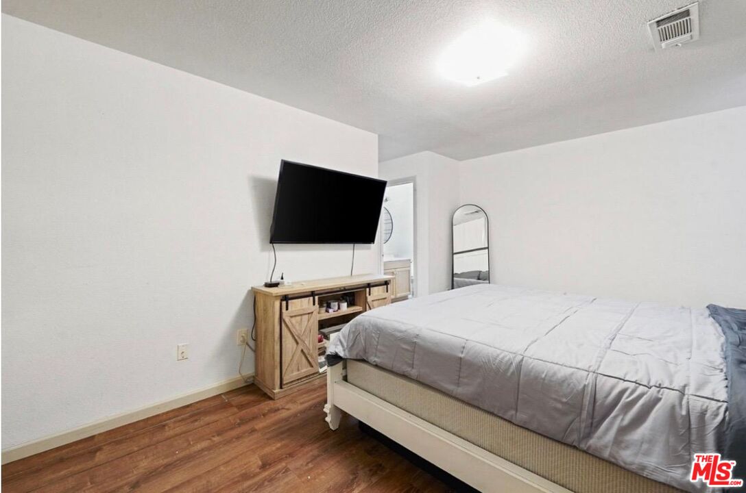 5612 McKee Road Bakersfield, CA 93313 - Photo 18 of 22 a bedroom with a bed and a flat screen tv