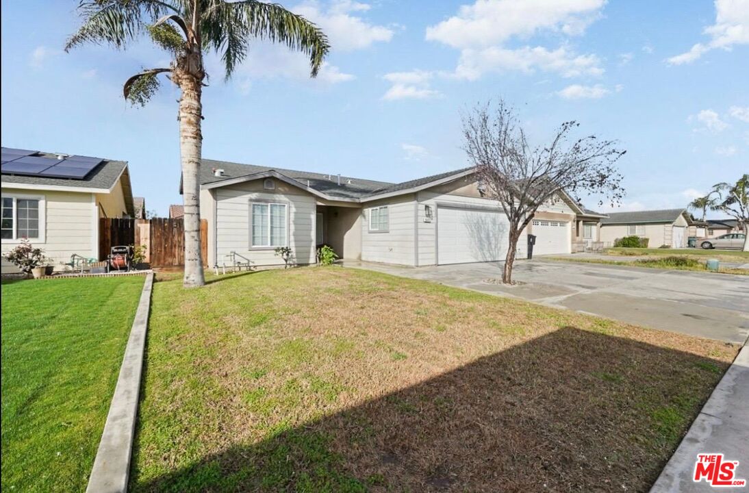 5612 McKee Road Bakersfield, CA 93313 - Photo 21 of 22 a view of a house with a yard and palm trees