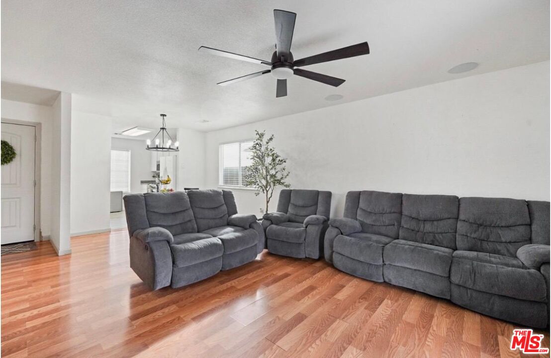 5612 McKee Road Bakersfield, CA 93313 - Photo 4 of 22 a living room with furniture and a chandelier