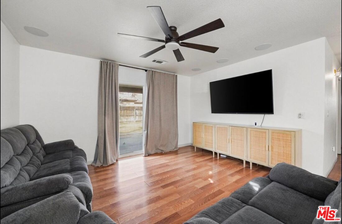 5612 McKee Road Bakersfield, CA 93313 - Photo 5 of 22 a living room with furniture and a flat screen tv
