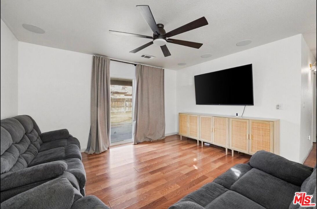 5612 McKee Road Bakersfield, CA 93313 - Photo 7 of 22 a living room with furniture and a flat screen tv