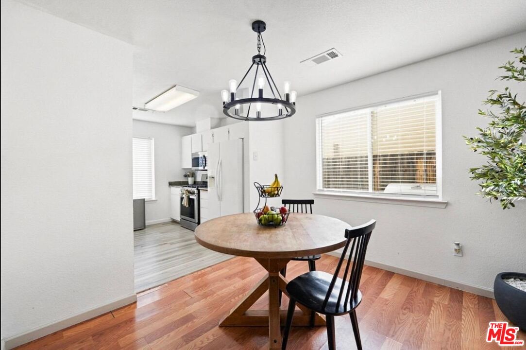 5612 McKee Road Bakersfield, CA 93313 - Photo 8 of 22 a view of a dining room with furniture window and wooden floor