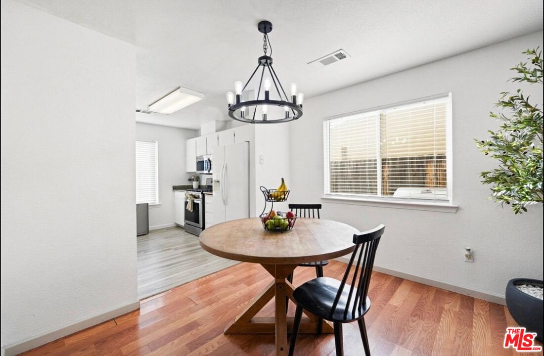 5612 McKee Road Bakersfield, CA 93313 - Photo 9 of 22 a view of a dining room with furniture window and wooden floor