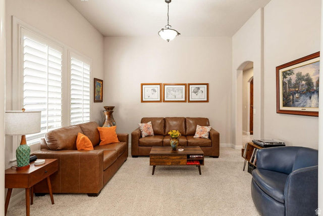 1609 East 10 S Street St. George, UT 84790 - Photo 10 of 68 Spacious living area featuring neutral carpeting, light-toned walls, and white plantation shutters
