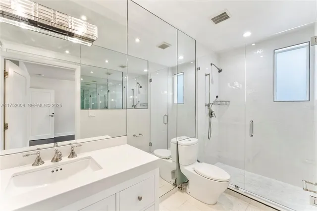 a view of a room that has a bed and wooden floor