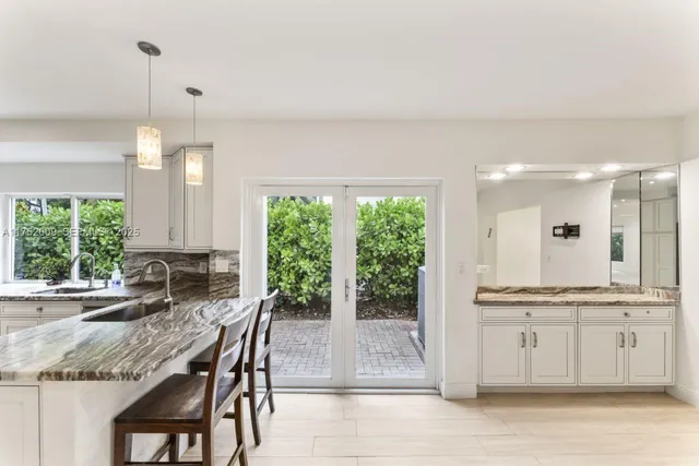 a bathroom with a sink a toilet a mirror and a glass door shower