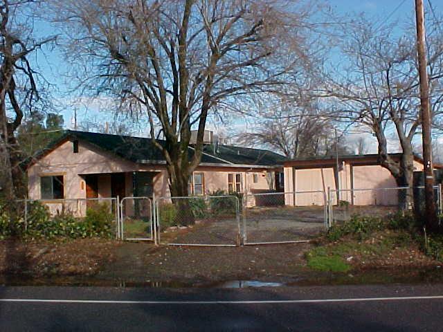 17972 Oasis Road Redding, CA 96003 - Photo 1 of 6 front view of house with a yard