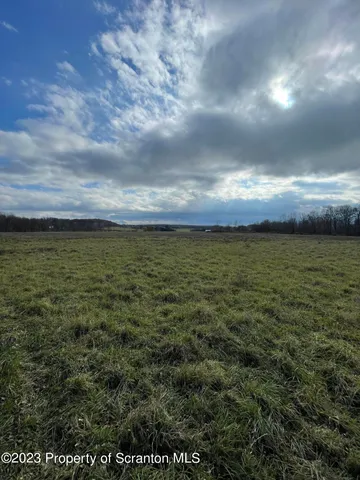 a view of a large body of water with a building in the background