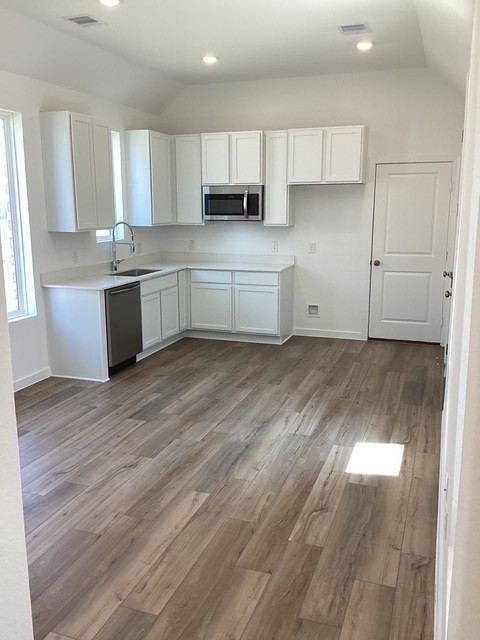 2703 Pine Bluff Drive Rosenberg, TX 77469 - Photo 7 of 24 a kitchen with granite countertop a sink cabinets and wooden floor