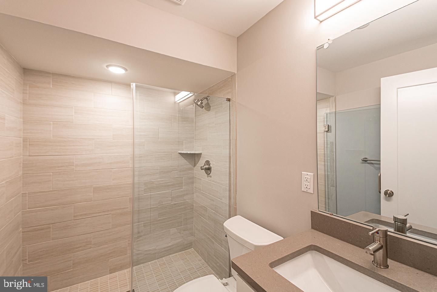 715 South 51st Street, Unit 1 Philadelphia, PA 19143 - Photo 12 of 18 a bathroom with a sink a toilet and shower