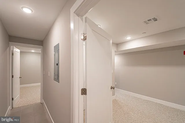 a bathroom with a shower and a glass door