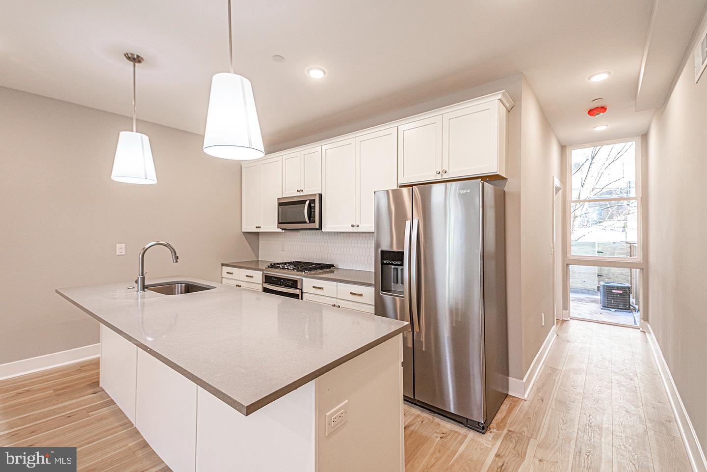 715 South 51st Street, Unit 1 Philadelphia, PA 19143 - Photo 2 of 18 a kitchen that has a lot of cabinets and refrigerator