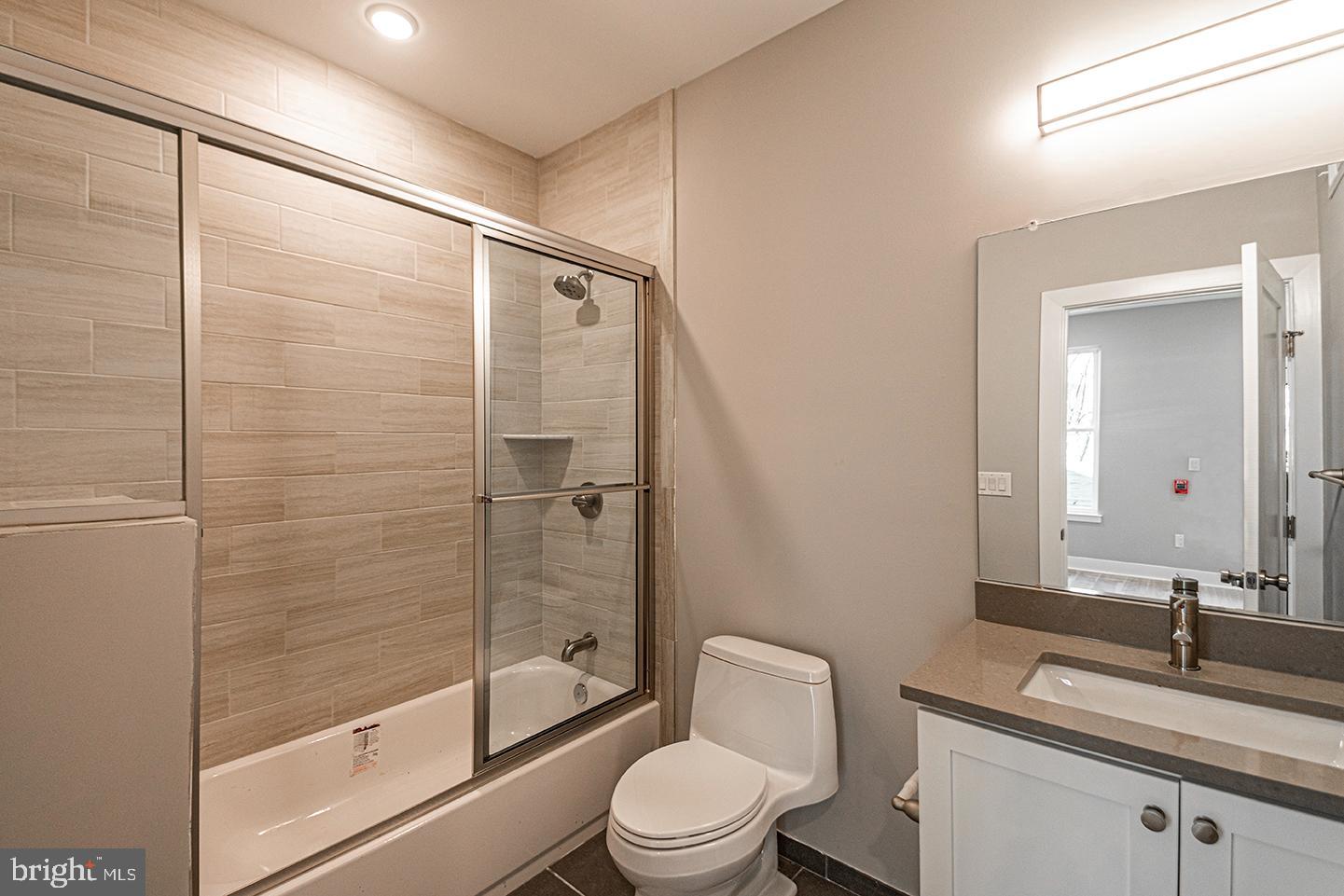 715 South 51st Street, Unit 1 Philadelphia, PA 19143 - Photo 5 of 18 a bathroom with a sink and a mirror