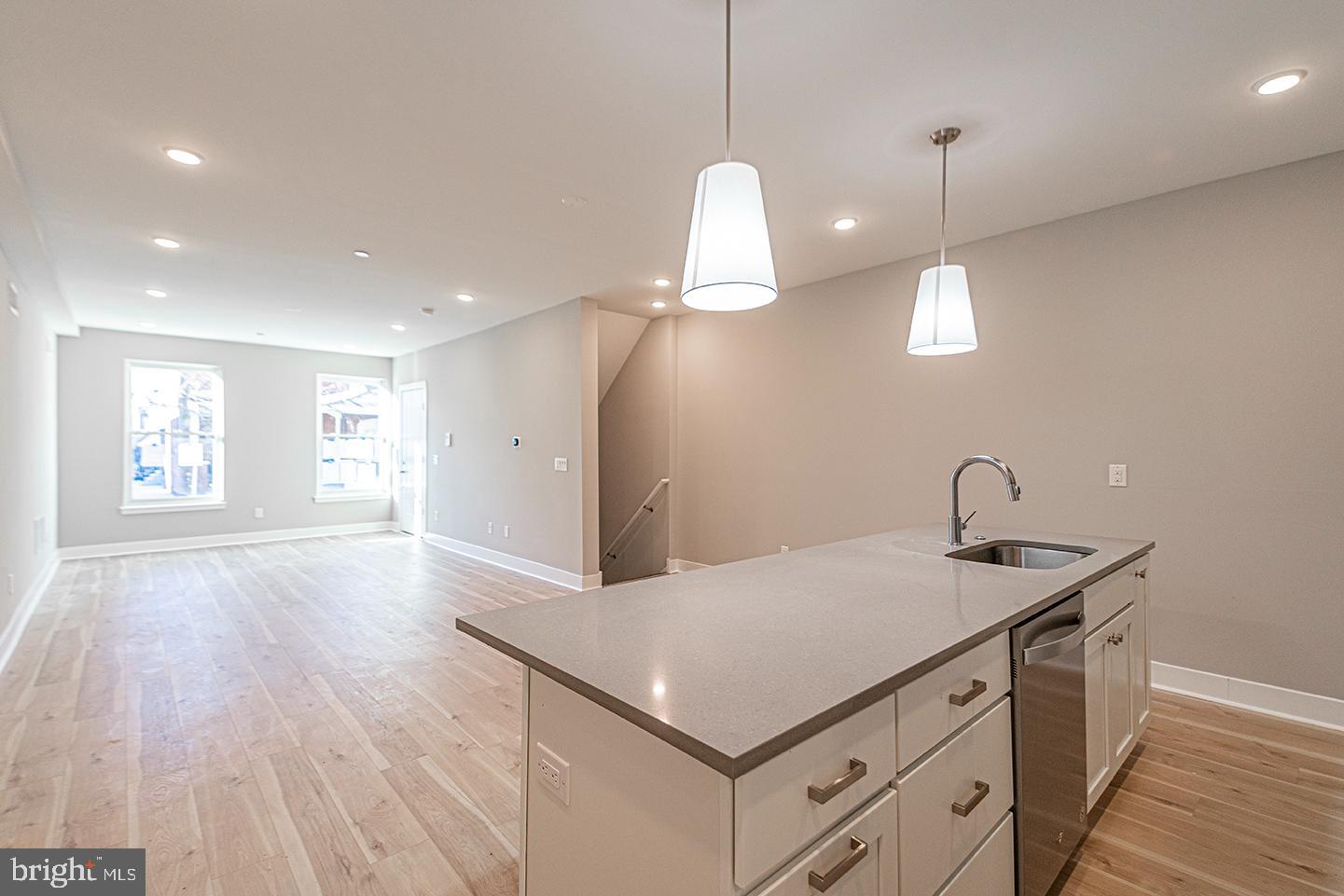 715 South 51st Street, Unit 1 Philadelphia, PA 19143 - Photo 8 of 18 a kitchen with a sink chandelier and wooden floor