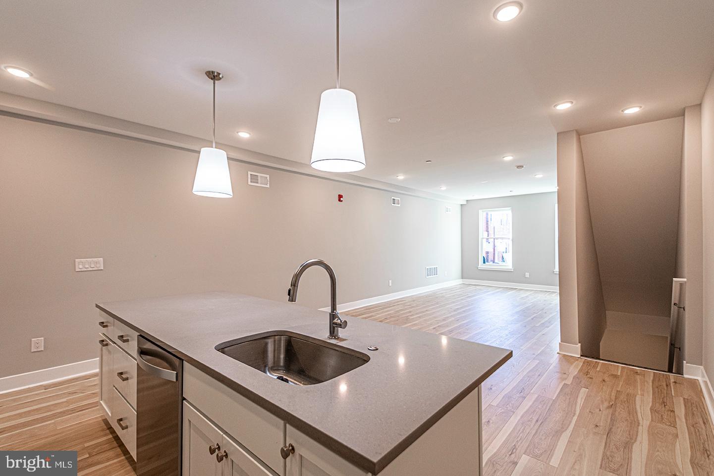 715 South 51st Street, Unit 1 Philadelphia, PA 19143 - Photo 9 of 18 a kitchen with kitchen island a sink appliances and a counter top space