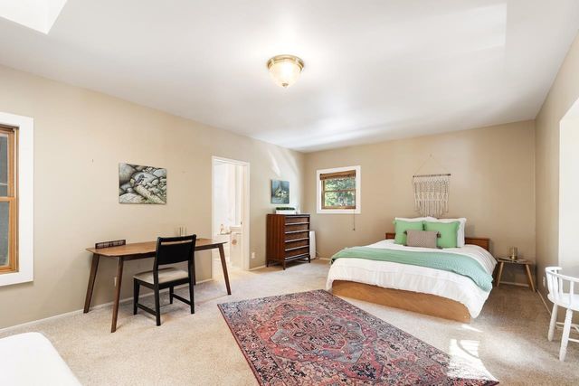 a bathroom with a sink a bed and a chandelier