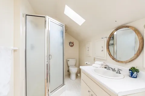 a bathroom with a sink toilet and mirror