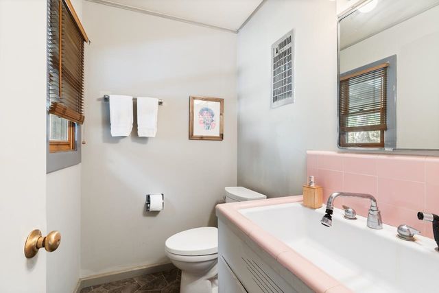 a view of a patio with table and chairs under an umbrella