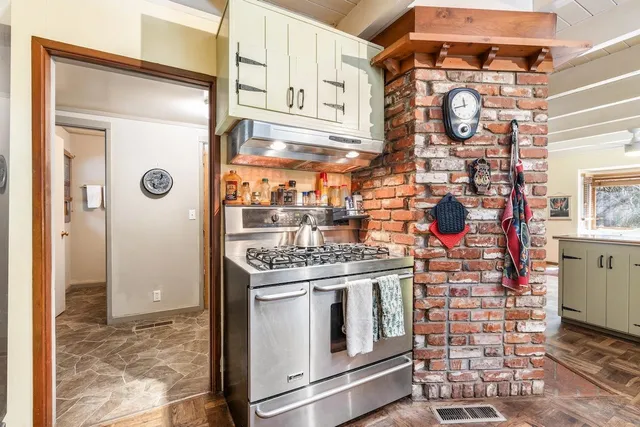 a kitchen with stainless steel appliances granite countertop a stove and a refrigerator