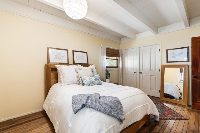 a bedroom with a bed and a large mirror