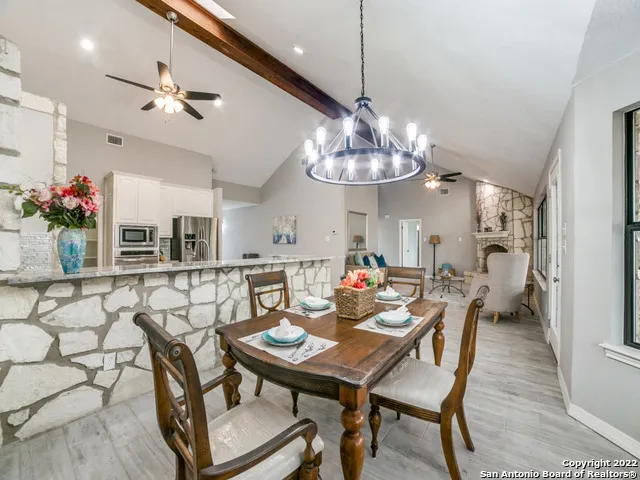a view of a dining room with furniture wooden floor and chandelier