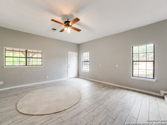 2580 Goat Hill Road Lakehills, TX 78063 - Photo 21 of 34 an empty room with windows and fan