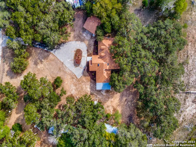 an aerial view of a house with a yard and fountain