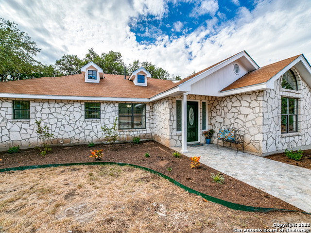 2580 Goat Hill Road Lakehills, TX 78063 - Photo 4 of 34 a view of a house with a yard and large tree