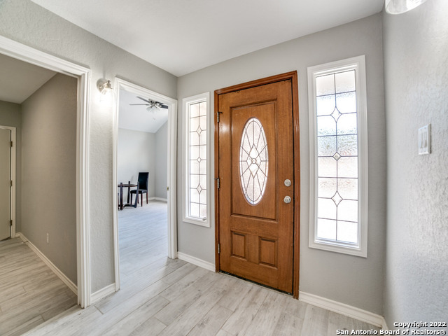 2580 Goat Hill Road Lakehills, TX 78063 - Photo 6 of 34 a view of a hallway with wooden floor windows and a bathroom