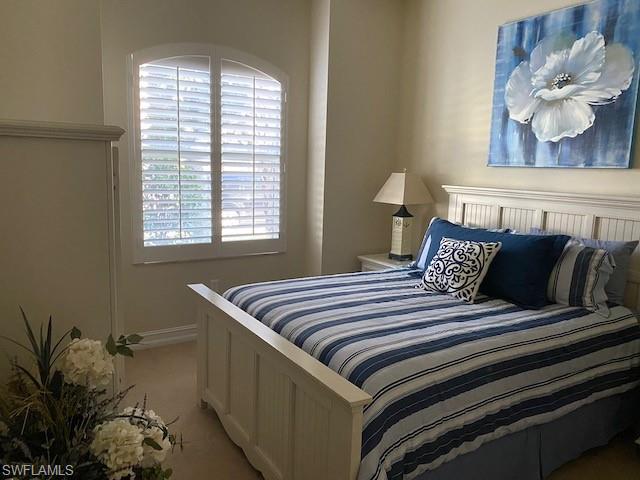 10307 Gator Bay Court Naples, FL 34120 - Photo 17 of 24 a bedroom with a bed and a window