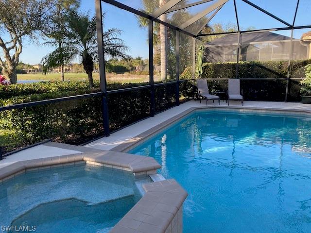 10307 Gator Bay Court Naples, FL 34120 - Photo 20 of 24 a view of a swimming pool with a patio
