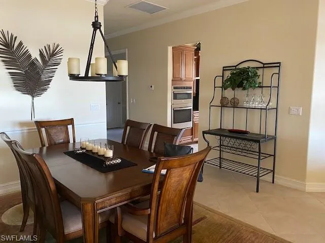 a dining room with furniture and a wooden floor