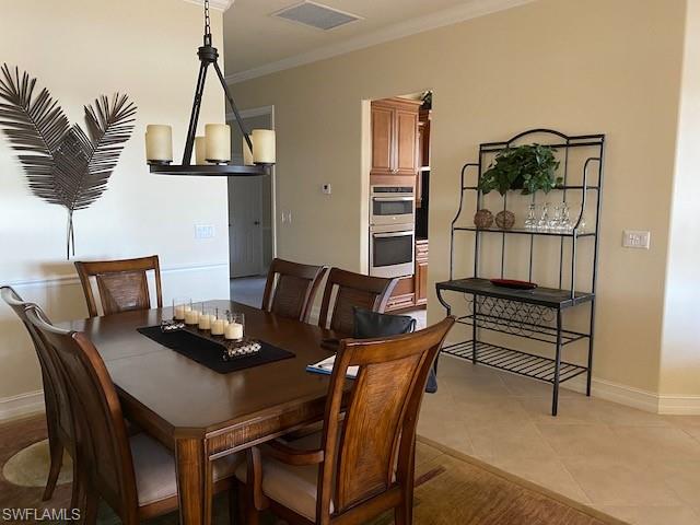 10307 Gator Bay Court Naples, FL 34120 - Photo 7 of 24 a dining room with furniture and a wooden floor