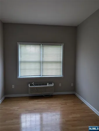 a view of a room with wooden floor and window