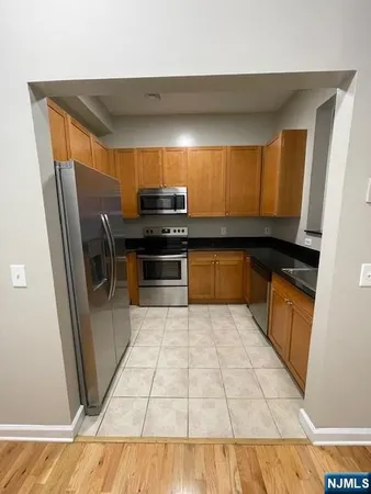 a kitchen with stainless steel appliances a sink and a counter