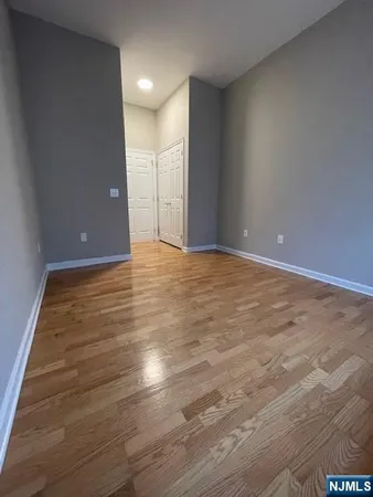 a view of an empty room with wooden floor