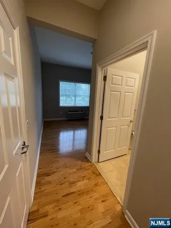 a view of a hallway with wooden floor and a hallway